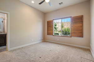 Spare room with ceiling fan and carpet