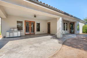 View of patio with a grill, ceiling fan, and french doors