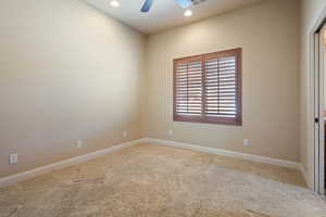 Empty room with carpet flooring and ceiling fan