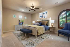 Carpeted bedroom featuring ceiling fan