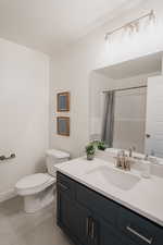 Pics are of model home.Bathroom with vanity, a shower with shower curtain, and toilet