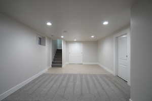 Basement with light colored carpet