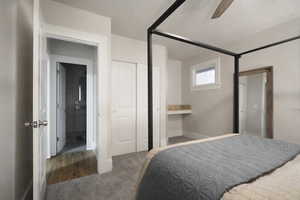 Carpeted bedroom featuring ceiling fan