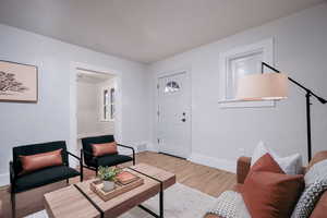 Living room with light hardwood / wood-style flooring