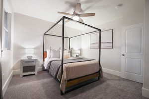 Carpeted bedroom featuring ceiling fan