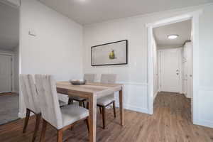 Dining space featuring light wood-type flooring and crown molding