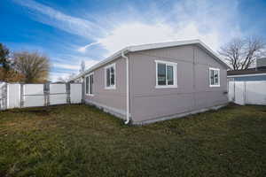 View of side of property featuring a yard