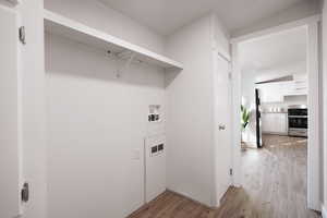 Laundry room featuring washer hookup and light wood-type flooring