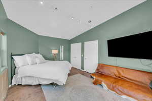 Bedroom featuring vaulted ceiling