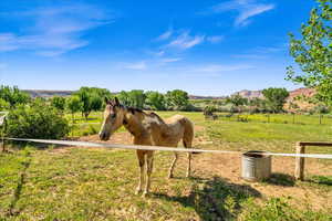 View of horse barn featuring a mountain view and a rural view