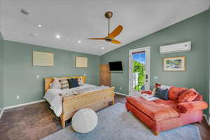 Bedroom with track lighting, an AC wall unit, vaulted ceiling, ceiling fan, and access to exterior