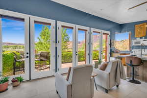 Doorway to outside featuring ceiling fan and french doors