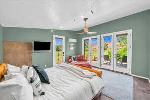 Bedroom with access to exterior, ceiling fan, french doors, a wall unit AC, and lofted ceiling