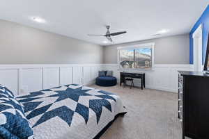 Carpeted bedroom with ceiling fan