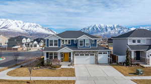 View of front of home featuring a mountain view and a garage