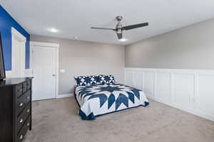 Carpeted bedroom with ceiling fan