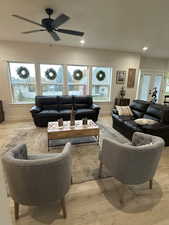 Living room featuring french doors, light hardwood / wood-style flooring, and ceiling fan