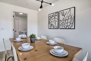 Dining area featuring separate washer and dryer and wood-type flooring