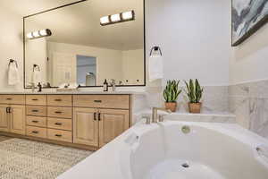 Bathroom with vanity and a relaxing tiled tub