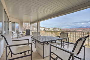 View of patio featuring a grill and a balcony