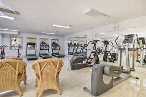 Workout area with light tile patterned floors