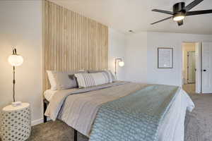 Carpeted bedroom featuring ceiling fan