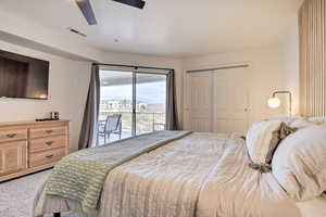 Carpeted bedroom with access to exterior, a closet, and ceiling fan