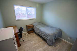 Bedroom with light hardwood / wood-style floors