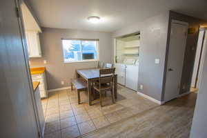 Tiled dining area with washing machine and dryer