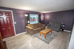 Living room with light hardwood / wood-style flooring