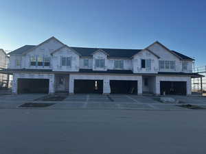 Unfinished property featuring a garage