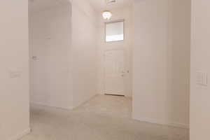 Hall featuring light tile patterned floors