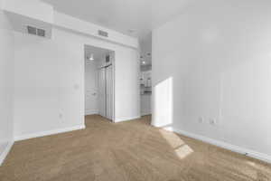 Unfurnished bedroom with carpet flooring, ensuite bath, and a closet