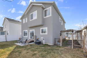 Rear view of house with a yard, a patio, and central AC unit