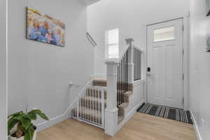 Entrance foyer with hardwood / wood-style flooring