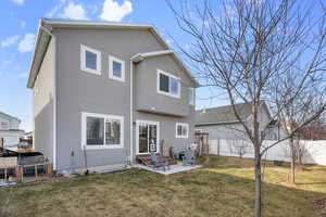 Rear view of house featuring a yard and a patio area