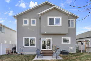 Back of property with cooling unit and a patio area