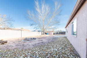 View of back yard with a storage shed