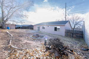 Rear view of house with an outdoor fire pit