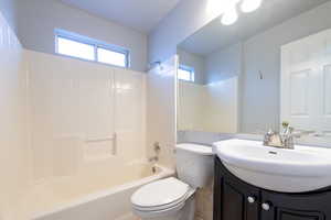 Full bathroom in hall with vanity,  shower combination, and toilet