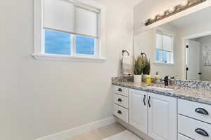 Bathroom featuring tile patterned flooring and vanity