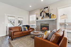 Living room featuring a tile fireplace and wood-type flooring