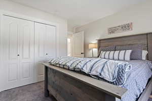 Bedroom with carpet flooring and a closet