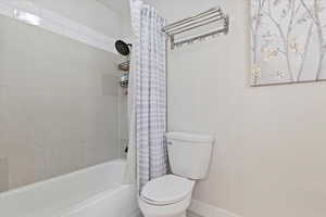 Bathroom with shower / bath combo and toilet