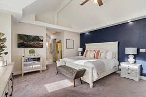 Carpeted bedroom featuring beamed ceiling, ceiling fan, and high vaulted ceiling