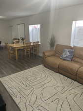 Living room with a healthy amount of sunlight and dark hardwood / wood-style flooring