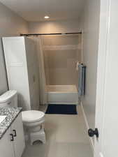 Full bathroom with shower / bath combination with curtain, vanity, and toilet