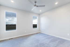 Carpeted empty room with ceiling fan