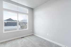 Empty room featuring light carpet