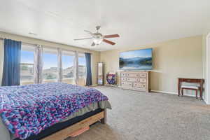 Bedroom featuring carpet and ceiling fan